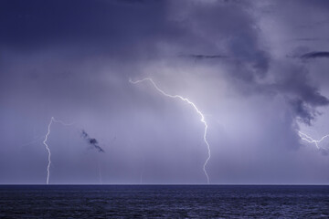 Thunderstorm over the sea,lightning beats the water