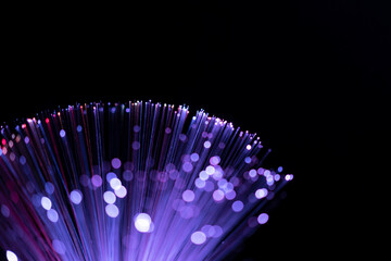 Fiber optic abstract neon lights colorful background. Close up view with bokeh. Glowing optical...