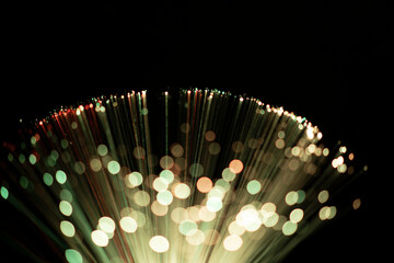 Fiber optic abstract neon lights colorful background. Close up view with bokeh. Glowing optical...