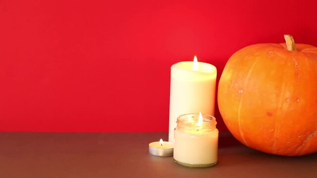 lighted candles with pumpking on table. Halloween atmosphere, decoration