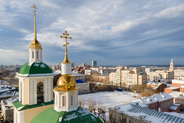 Fototapeta na wymiar Aerial view of Perm city in winter sunny day,church and lots of buildings with river Kama in the background