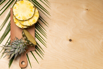 Pineapple cut on a wooden board, tropical diet