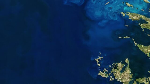 Blue sea satellite view, rotating spiral microorganism blossom around Falkland Islands animation. Images furnished by Nasa