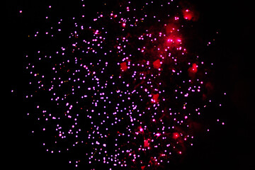 Starfall of purple fireworks lights during Christmas, New Years and Halloween