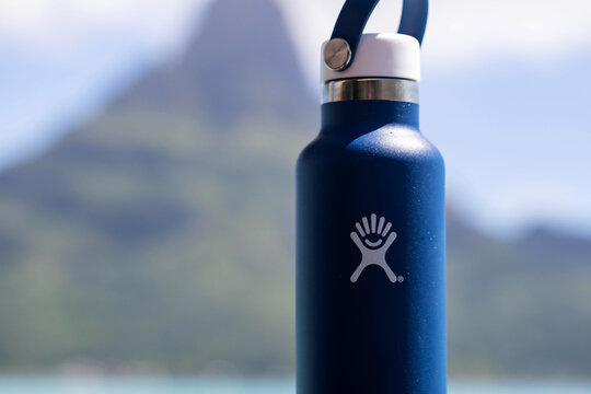 August 9, 2020, Bora Bora, French Polynesia: General view of blue hydroflask water bottle near tropical island of Bora Bora
