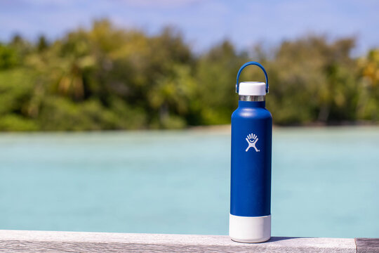 August 9, 2020, Bora Bora, French Polynesia: General view of blue hydroflask water bottle near tropical island of Bora Bora