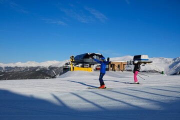 Colorful silhouettes of skiers on ski slope Monte Elmo/Helm in 3 Zinnen Dolomites in Italy on...