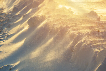 Snow pile in shadow during sunset in winter evening
