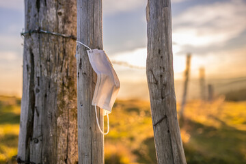 Surgical mask left in natural environment, covid, coronavirus, pollution, waste in nature