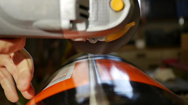 slow motion shot of angle grinder grinding metal canister. DYI recycling projet for the house. metalwork and metalart with abrasives and flapdisc on scrapmetalart using grinder tools.
