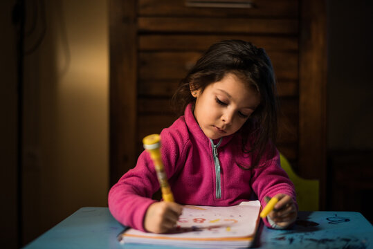 Drawing little girl at home