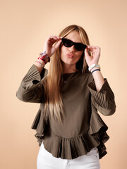 Pretty young woman with cheerful fitness, sunglasses and sticking out snouts