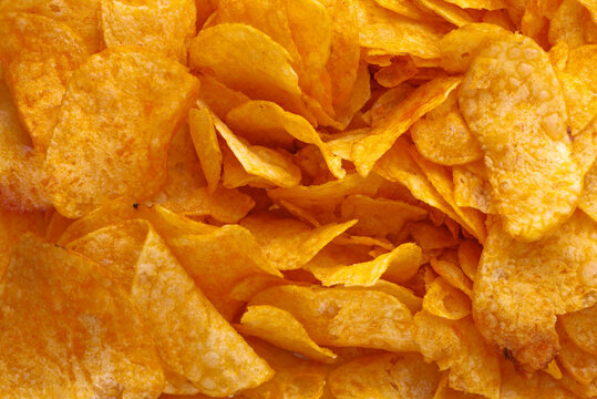 Potato chips or crisps . Close-up of potato chips or crisps. Food background.