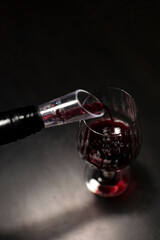 Red wine glass on the dinner table. Liquid concept design. Wine tasting at home