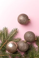 Christmas toy balls and fir tree on pink background 