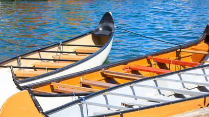 Three colorful vintage style canoes in Lake Ontario 