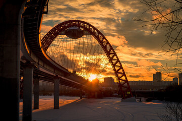 Zhivopisny suspension bridge winter sunset landscape in Moscow, Russia. Red beautiful modern suspension bridge 