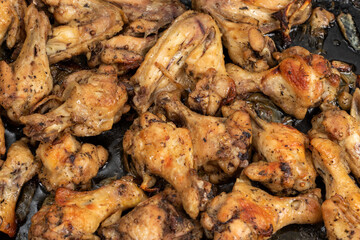 Frying pan with fried chicken breast and garlic