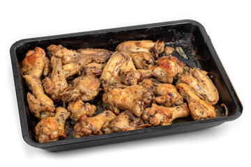 Frying pan with fried chicken breast and garlic
