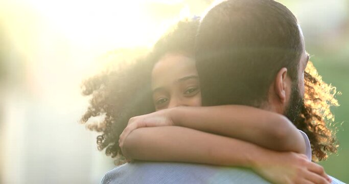Daughter hugging father outside. Mixed race ethnicity little girl hugs dad