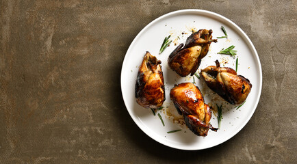 Roasted quails on plate