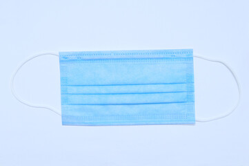 Medical blue mask close-up on  white background.