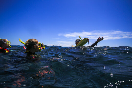 Training in snorkeling on water. Students and teacher at sea. Great barrier reef