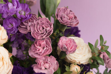 Fototapeta premium Bouquet in lilac tones on a purple background.