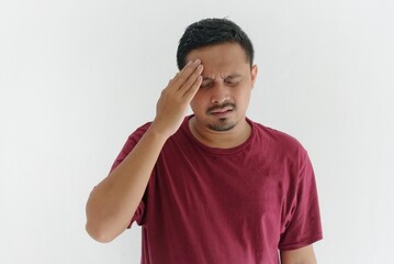 young adult asian man suffering headache, hand on the head, isolated in white