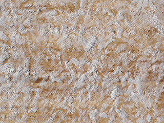 Wax on a brown surfboard, background texture.