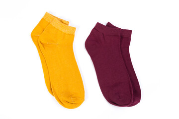 two pairs of colored short socks on a white background, top view