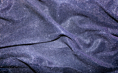 Creased and sparkly material making beautiful purple background