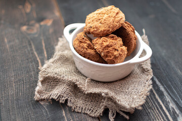 golden brown homemade oatmeal cookies on dark table