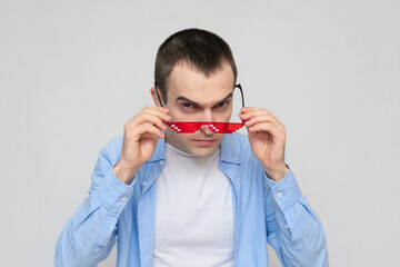 Man film fan shoots pixel glasses, portrait, white background