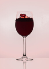 Red wine glass on the bright background
