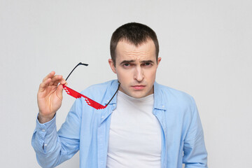 Funny film fan shoots pixel glasses, portrait, white background