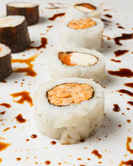 Vertical shot of fresh sushi rolls on white background