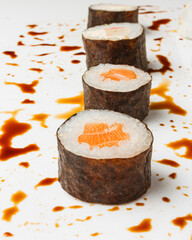 Vertical shot of fresh sushi rolls on white background