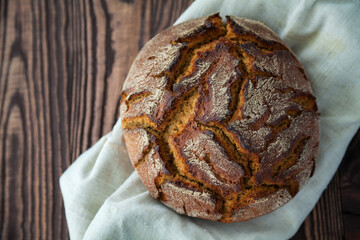 top view rye circle bread in a linen cloth
