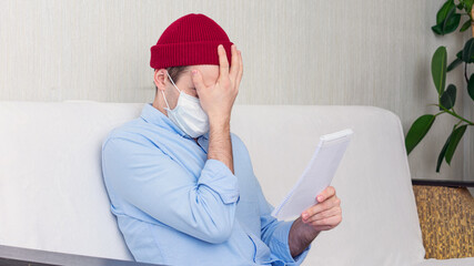 Upset man in a medical mask hold a notebook, portrait, 16:9