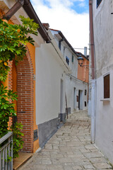 Fototapeta na wymiar A narrow street among the old houses of Ailano, a medieval village in Campania region, Italy.