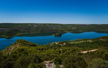 Fototapeta na wymiar Visovac island with monastery on Krka river in National park Krka, Croatia. September 2020