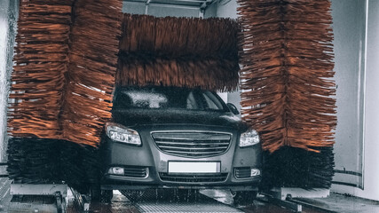 Foam water clean auto car on carwash hand service. Vehicle wash soap, foam on cleaner station.