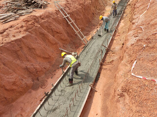 KUALA LUMPUR, MALAYSIA - November 20, 2020: Construction workers are leveling a layer of lean...