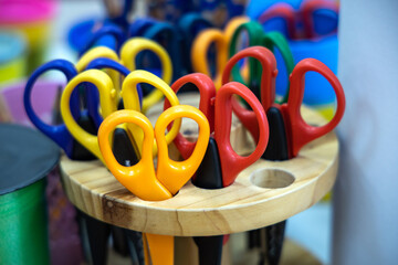 box of colored scissors in an elementary classroom or kindergarten