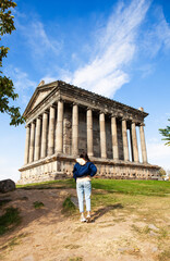 The young woman standing in front of Temple of Garni, Armenia - 393974019