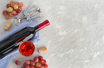 Wine glass, bottle of wine and bunches pink grape