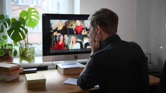 Man Fatigue during home video conference meeting call. Post-work exhaustion from constant face-to-face digital interactions. Working remotely Stay connected during pandemic to combat loneliness