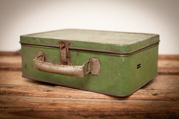 Vintage Rusty Green Metal Lunchbox on Old Wooden Trunk