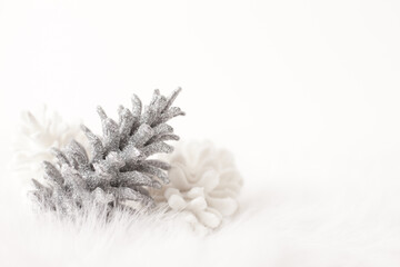 Fototapeta na wymiar Decorative Holiday Pine Cones on Snow-Like Background, Room for Text